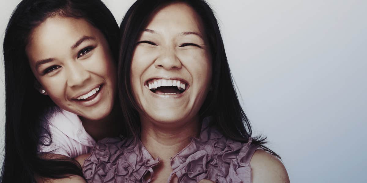 mom and teen daughter laughing