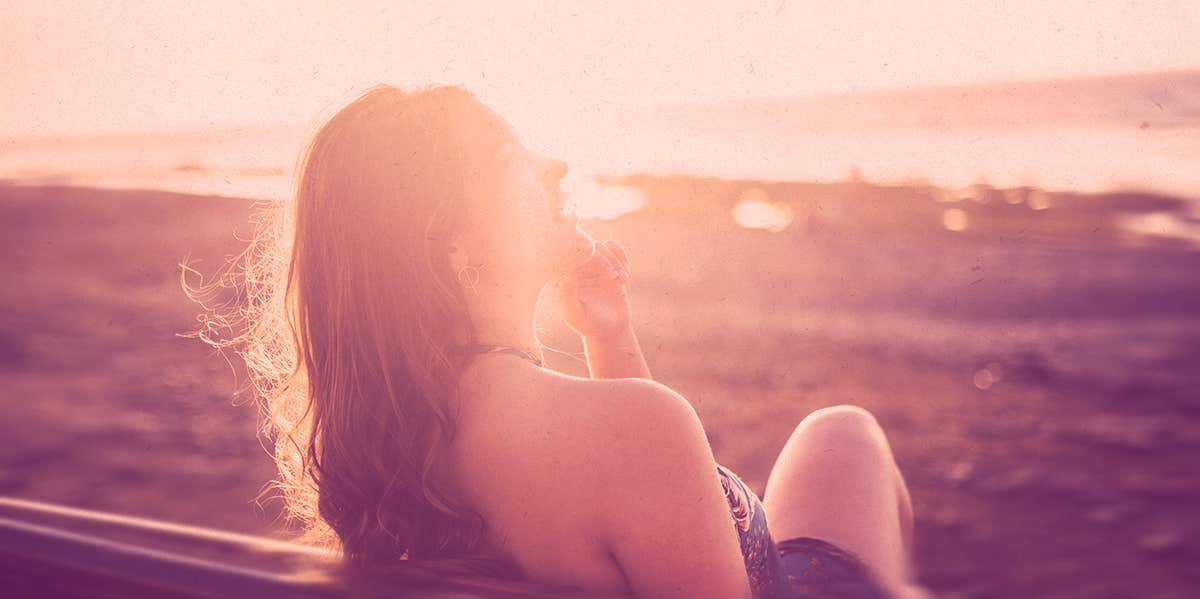 Why My Divorce Was The Best Thing I Ever Did woman sitting at the beach, sunset