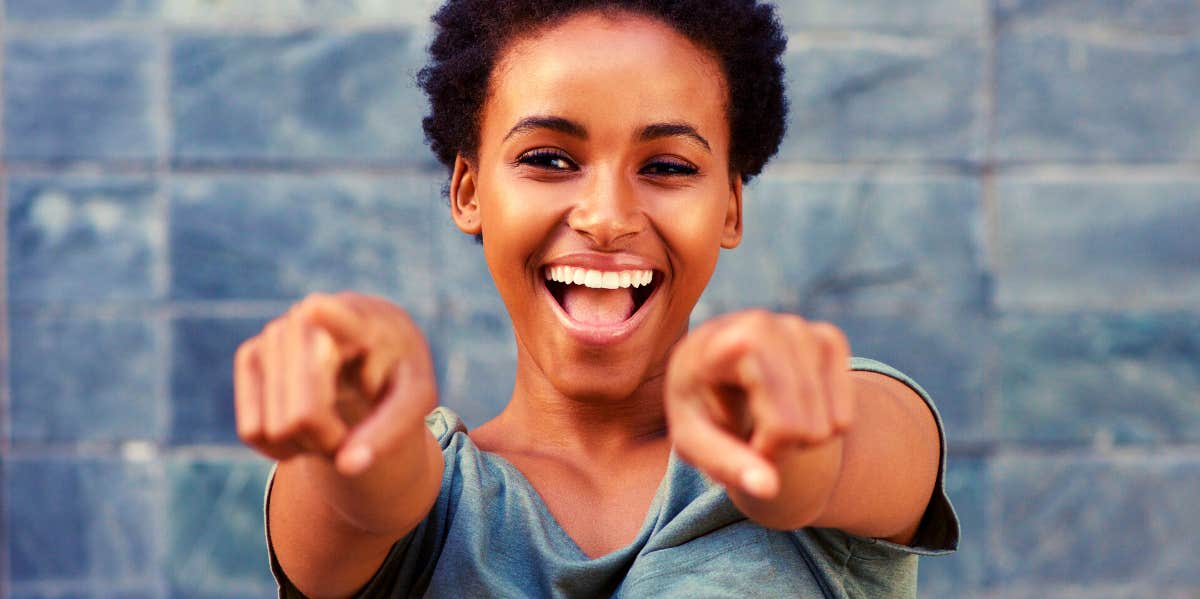 smiling woman pointing at the camera