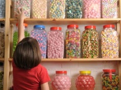 little girl reaching for candy