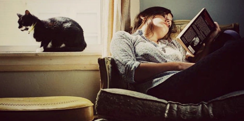 girl reading with her cat