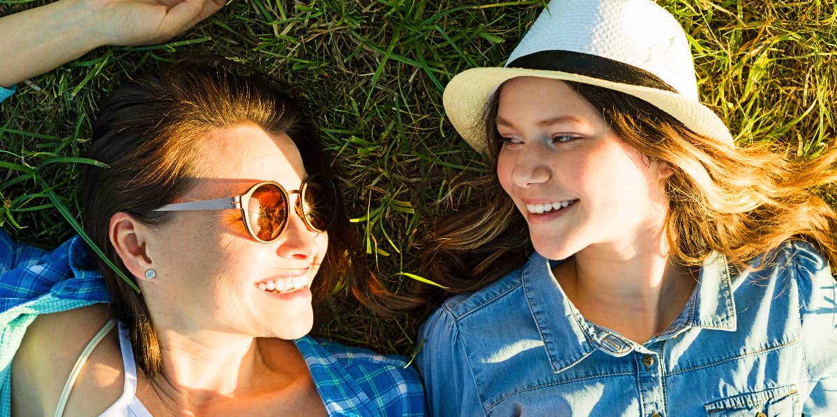 Mom and teen daughter relax outside