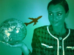 Woman holding globe and plane