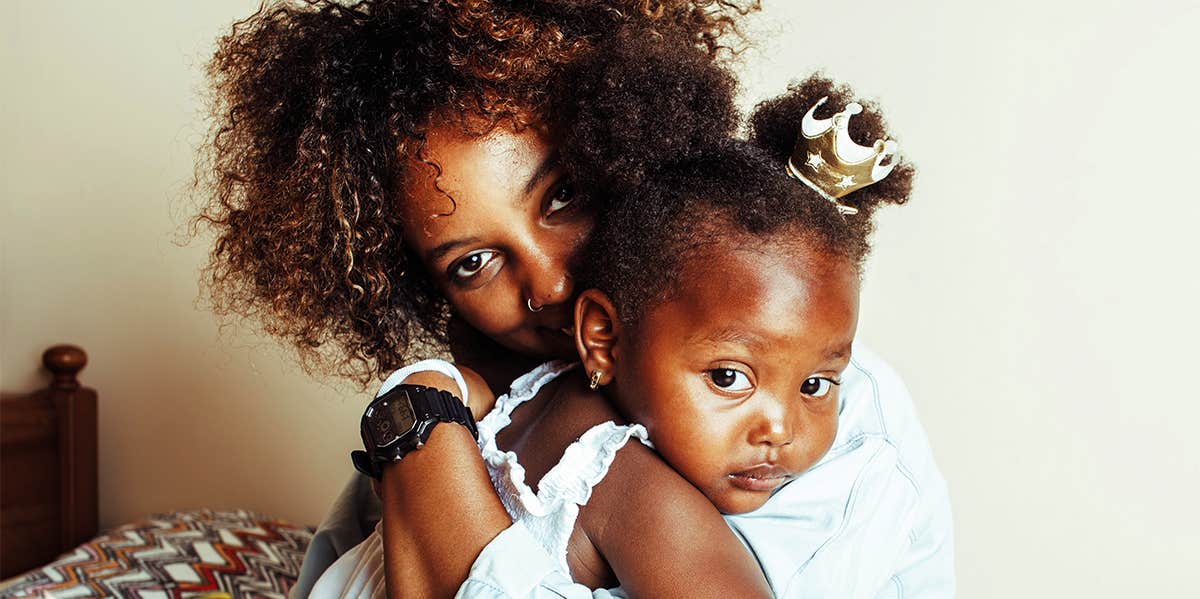 black mother holding daughter