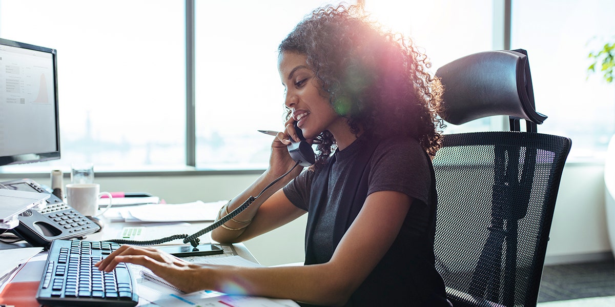 woman at desk typing working