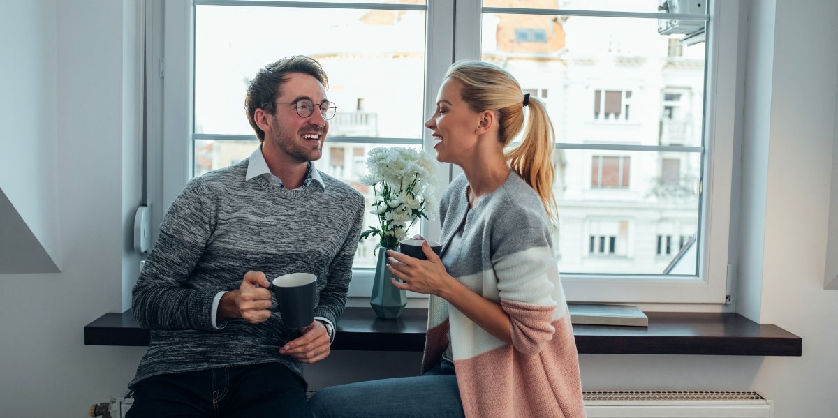 couple talking in front of window