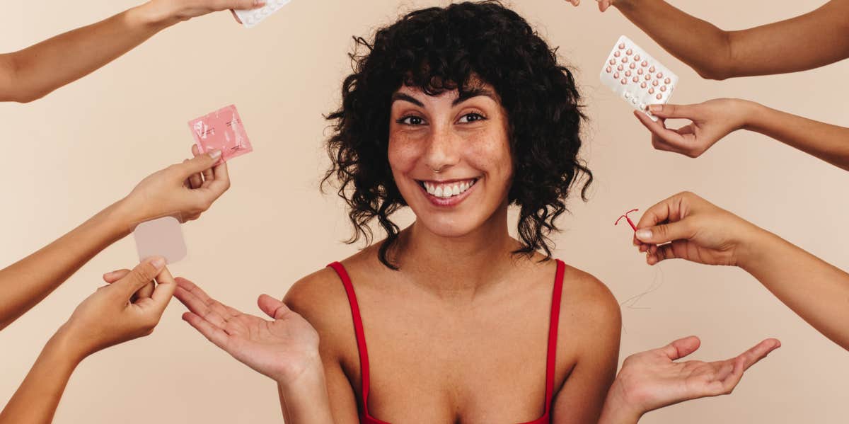 I Got An IUD To Help With My Period Pain, And Here’s My Experience woman surrounded by birth control options