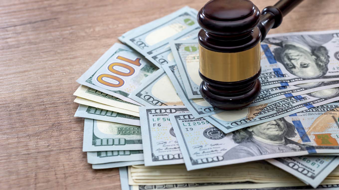 gavel on top of pile of $100 bills