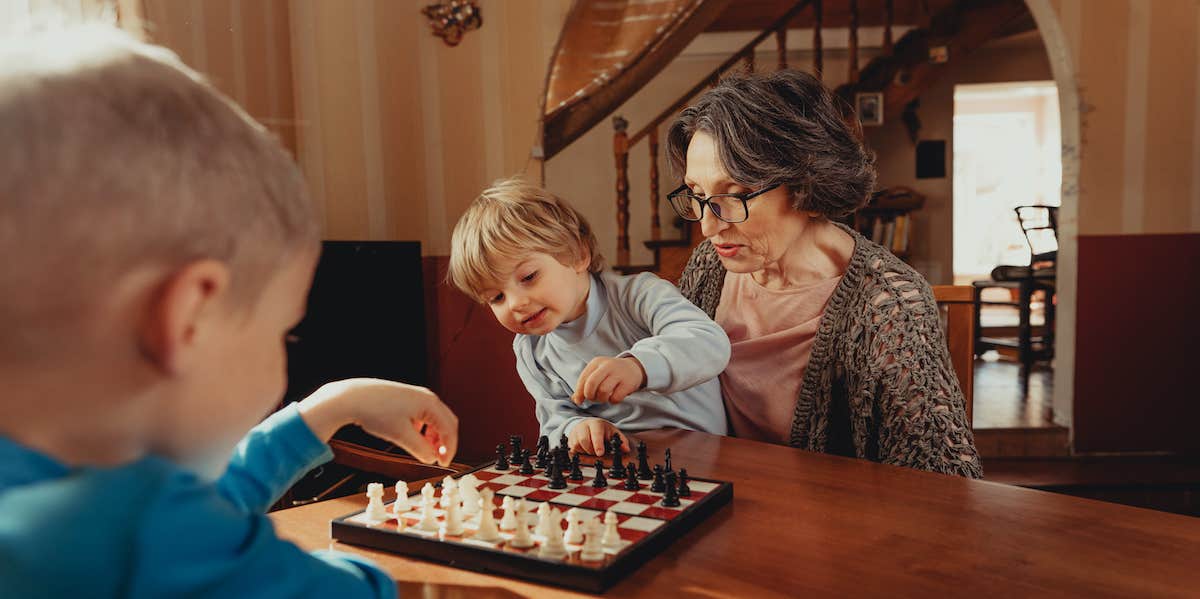 grandmother teaching grandson chess