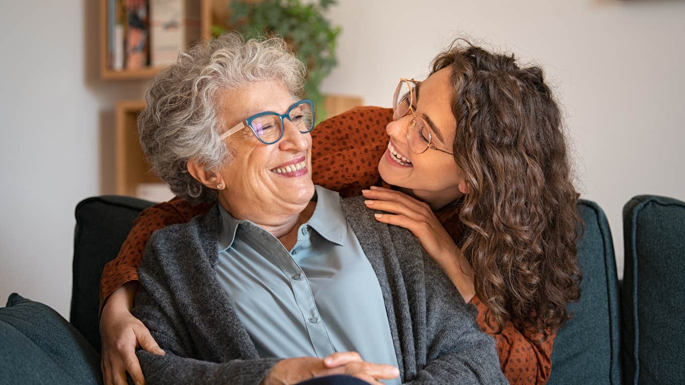 grandmother and granddaughter hugging at home and looking at each other.