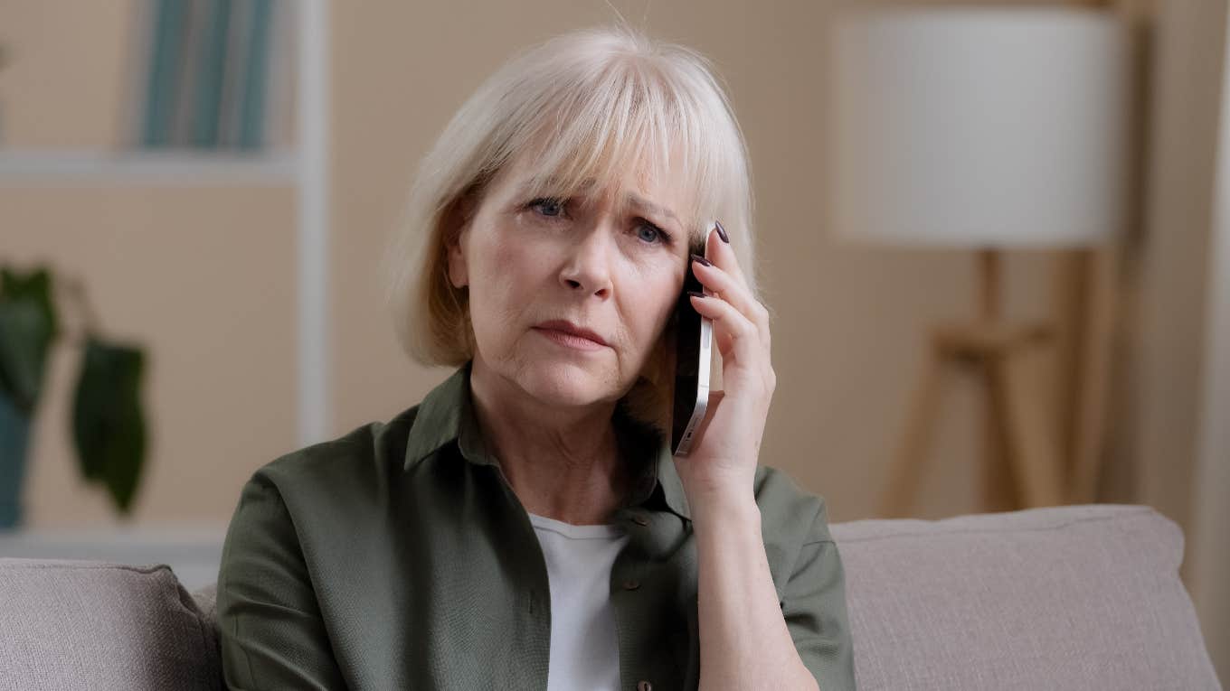 upset older woman talking on a cell phone