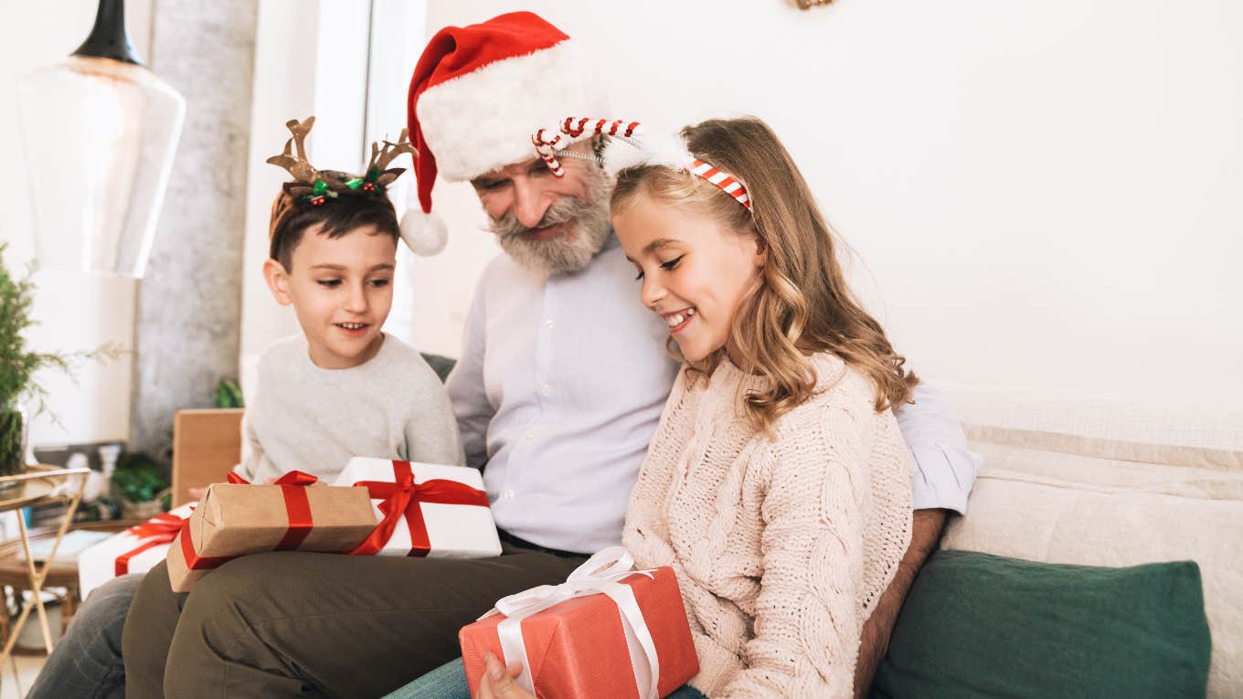 grandfather giving grandchildren christmas gifts