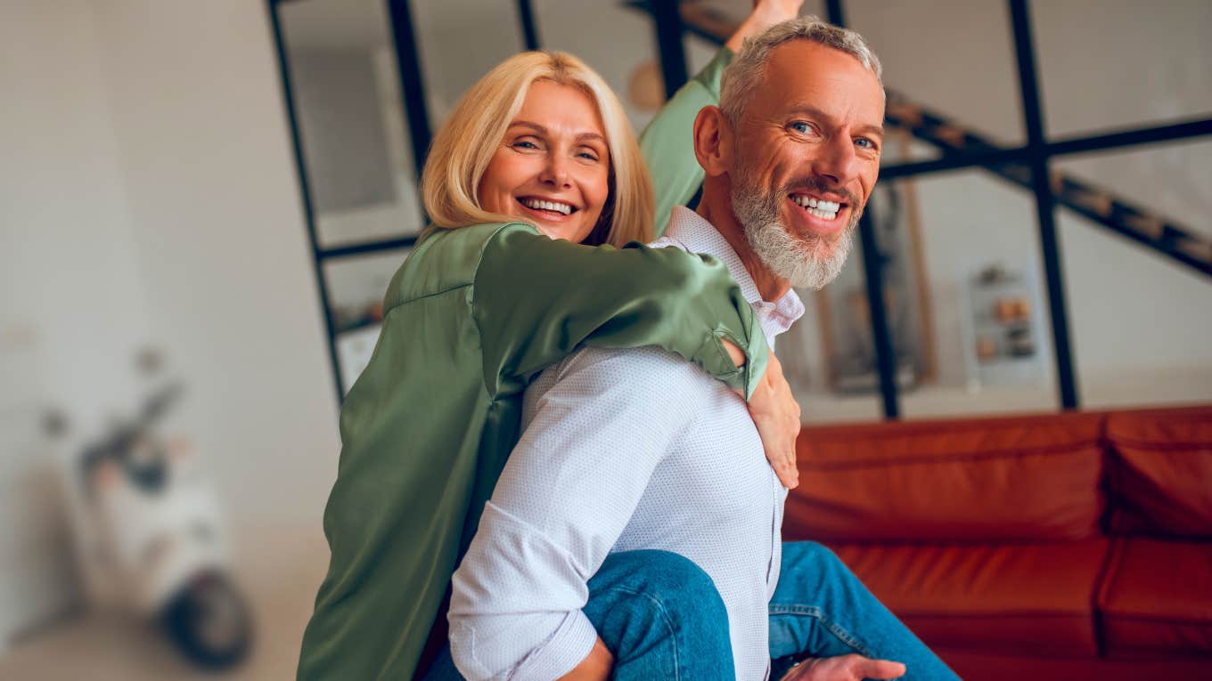 Man holding his wife on his back and both feeling awesome