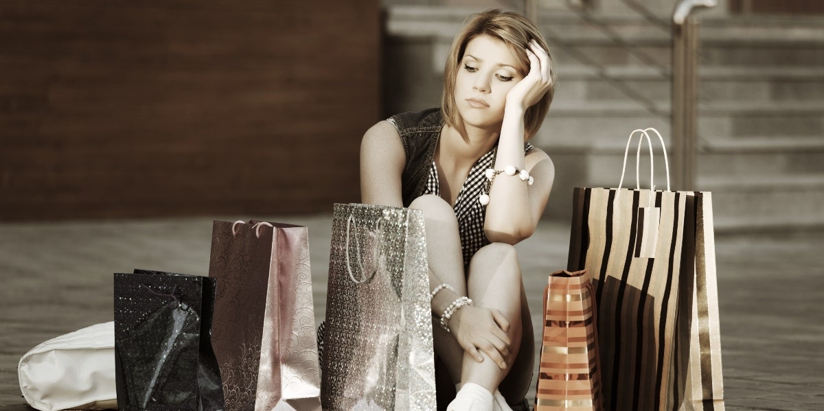 woman sitting on the floor with shopping bags
