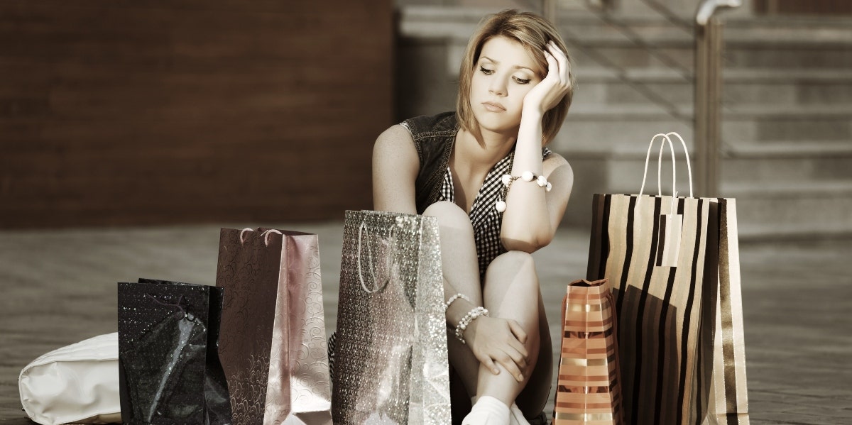 grief shopping woman sitting on the floor with shopping bags