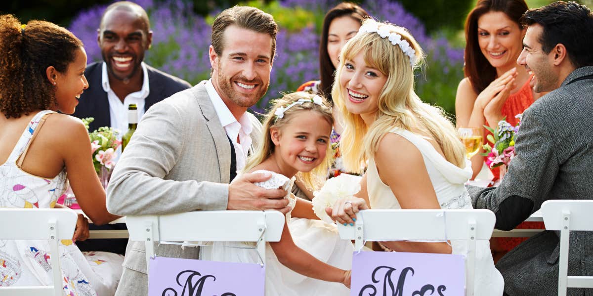 Groom and bride with their daughter at wedding