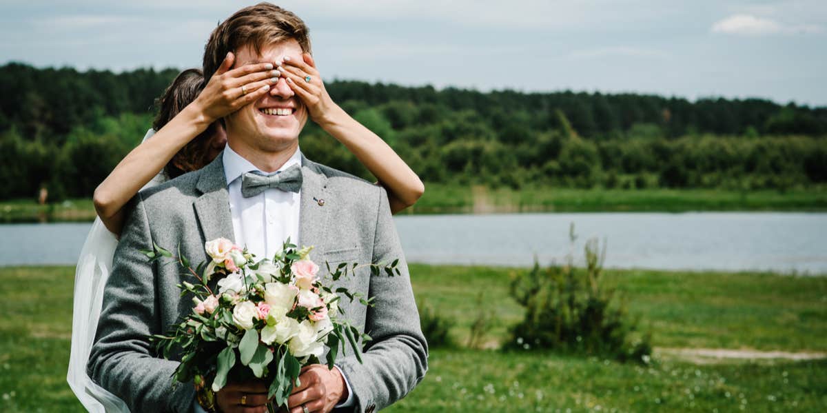 bride behind groom