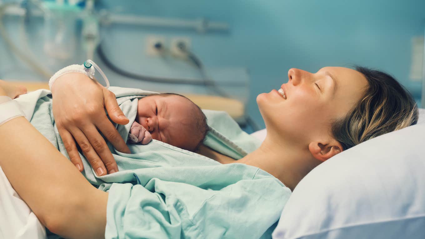 Woman post birth with baby on chest 