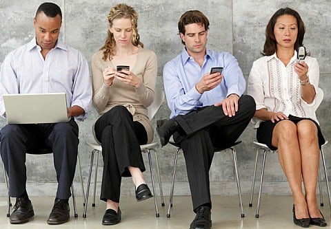 group of people using cellphones