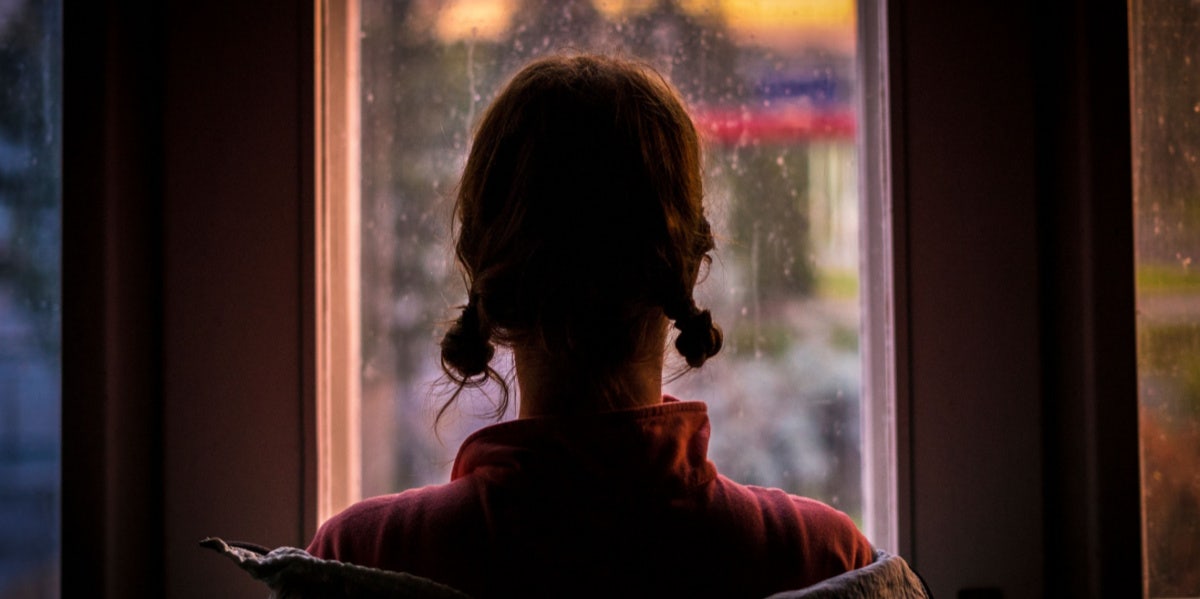 woman looking out a window