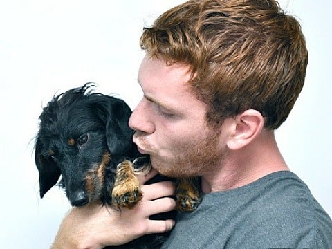 guy kissing dog