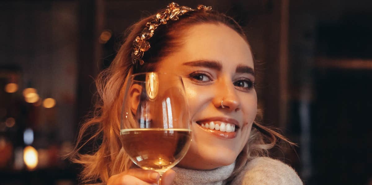 woman holding a glass of wine