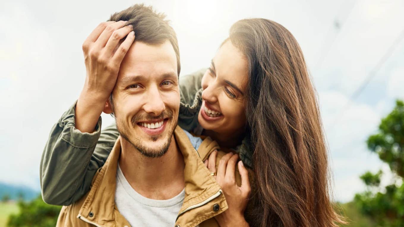 10 Essential Habits All Couples Need To Do To Build A Strong Relationship happy couple smiling at camera