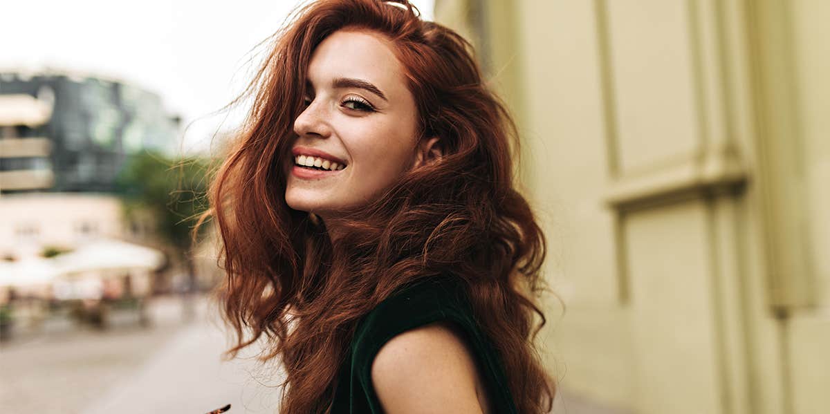 woman with wavy hair looking at camera