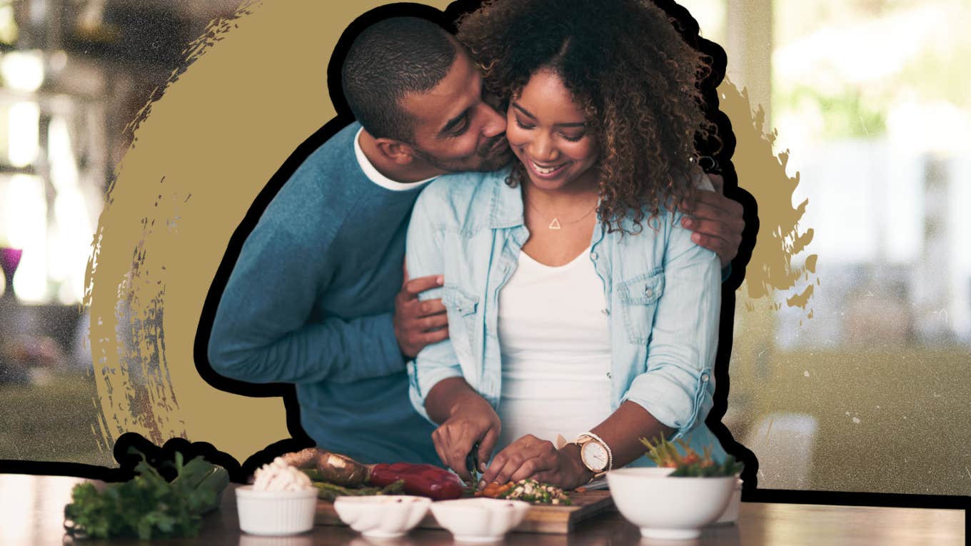 Man appreciating woman while she cooks 