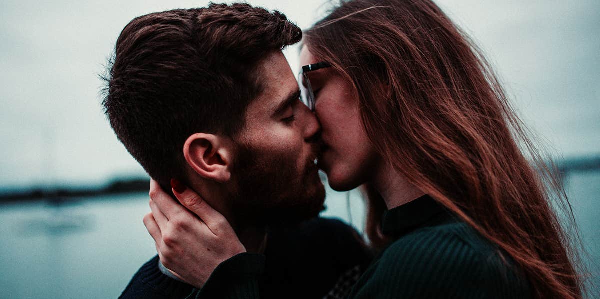 man with beard kissing woman