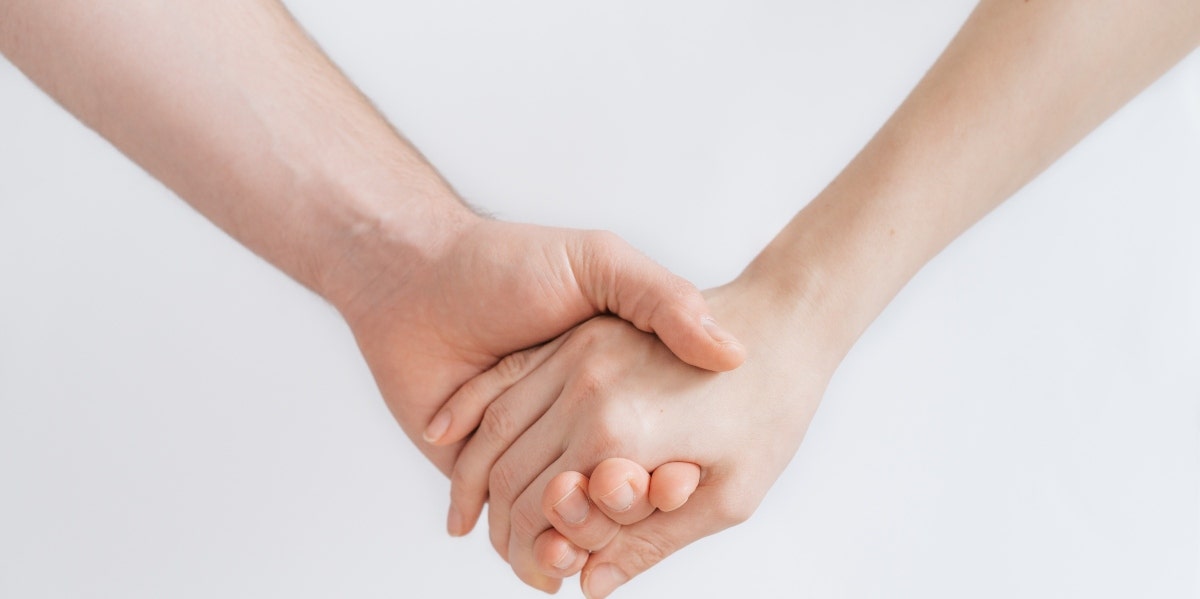 two caucausian hands, clasped 