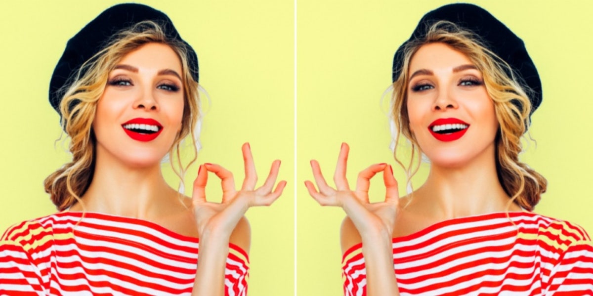 woman making ok sign with hand red striped shirt