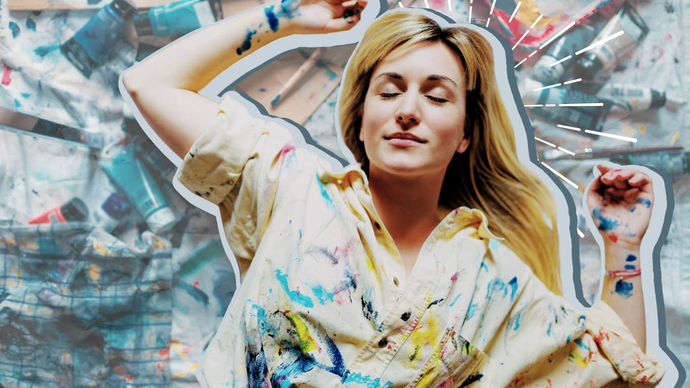 Happy woman sitting in a metaphorical mess
