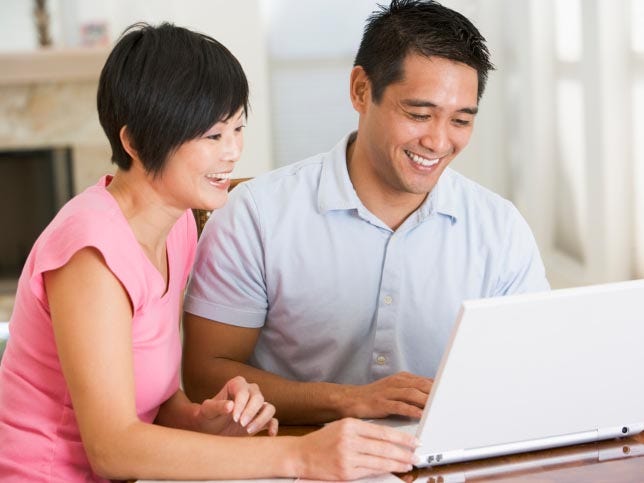 happy couple using computer