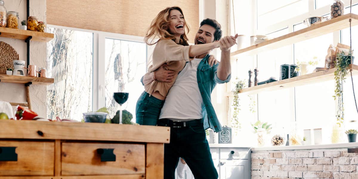 silly couple dancing in their kitchen