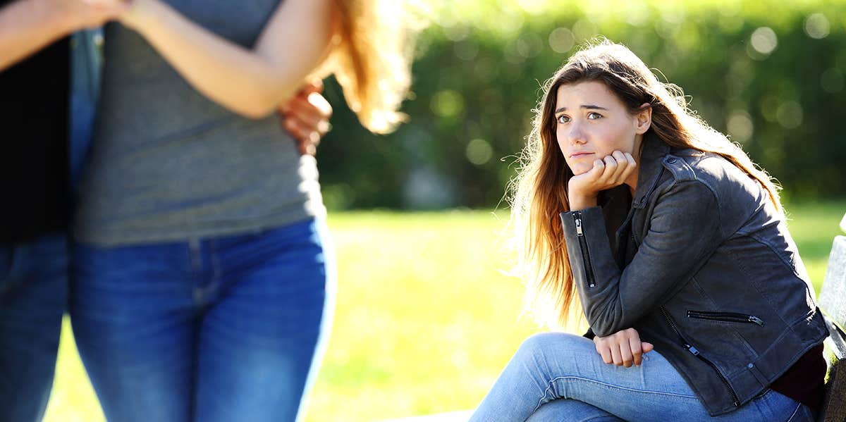 woman sadly looking at couple 