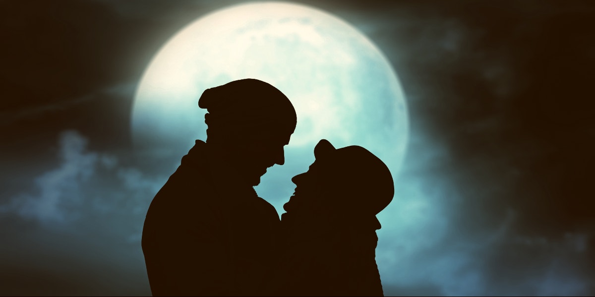couple in front of the moon couple in front of the moon