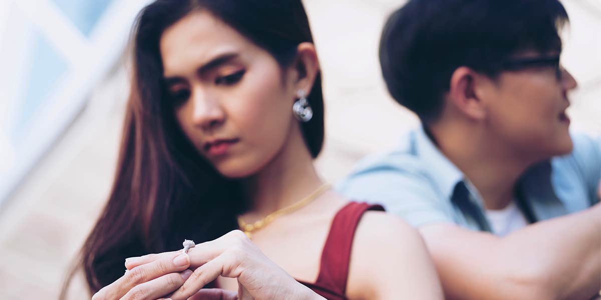 woman taking off wedding ring