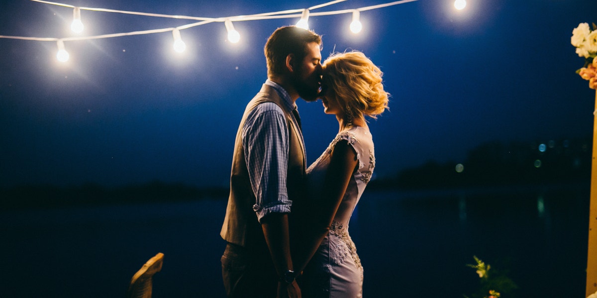 man and woman dancing under lights