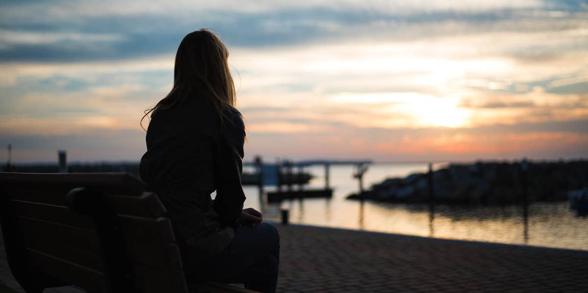 woman sitting alone on bench