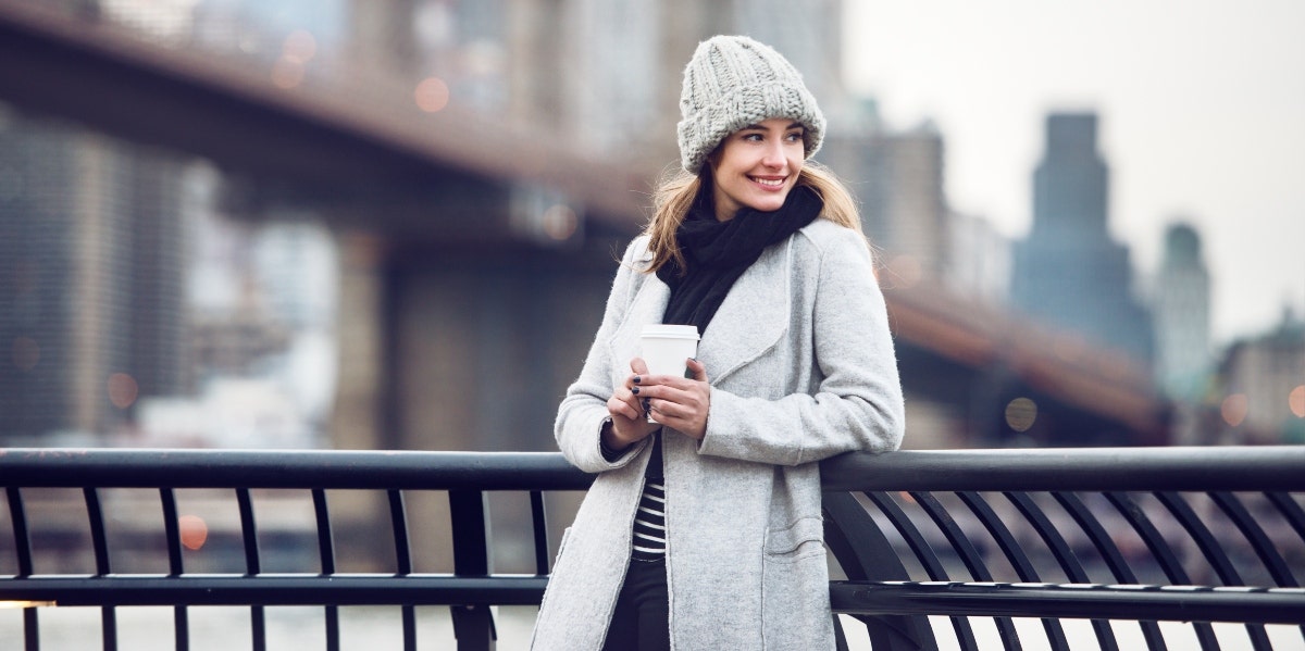 smiling woman in white coat 