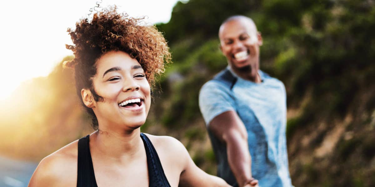 couple hiking and laughing togehter