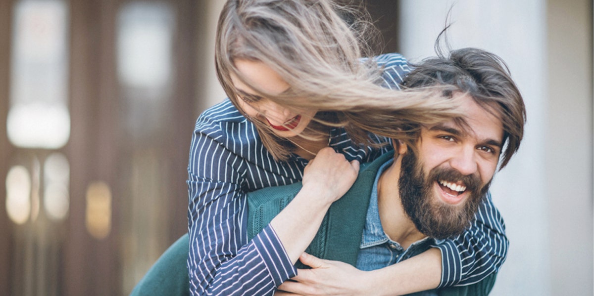 man carrying woman on back