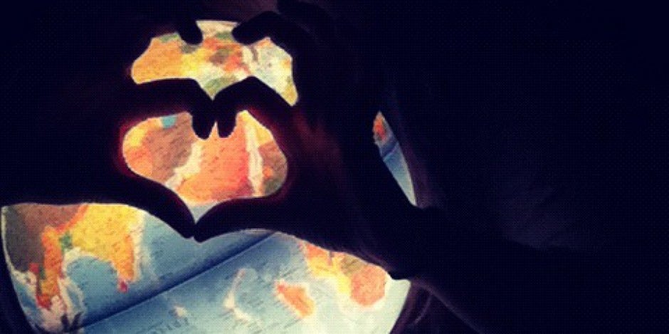 hand heart over the globe hand heart over the globe
