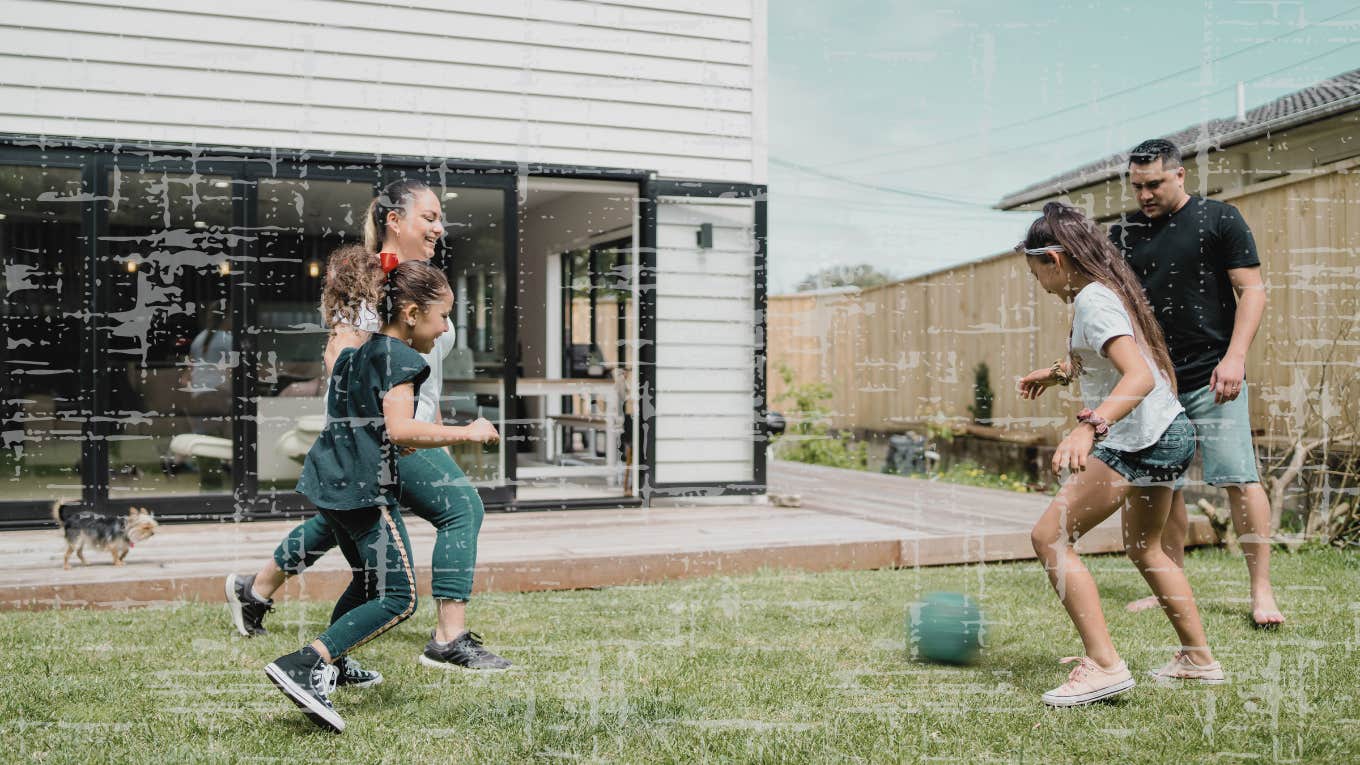 family playing soccer outside together