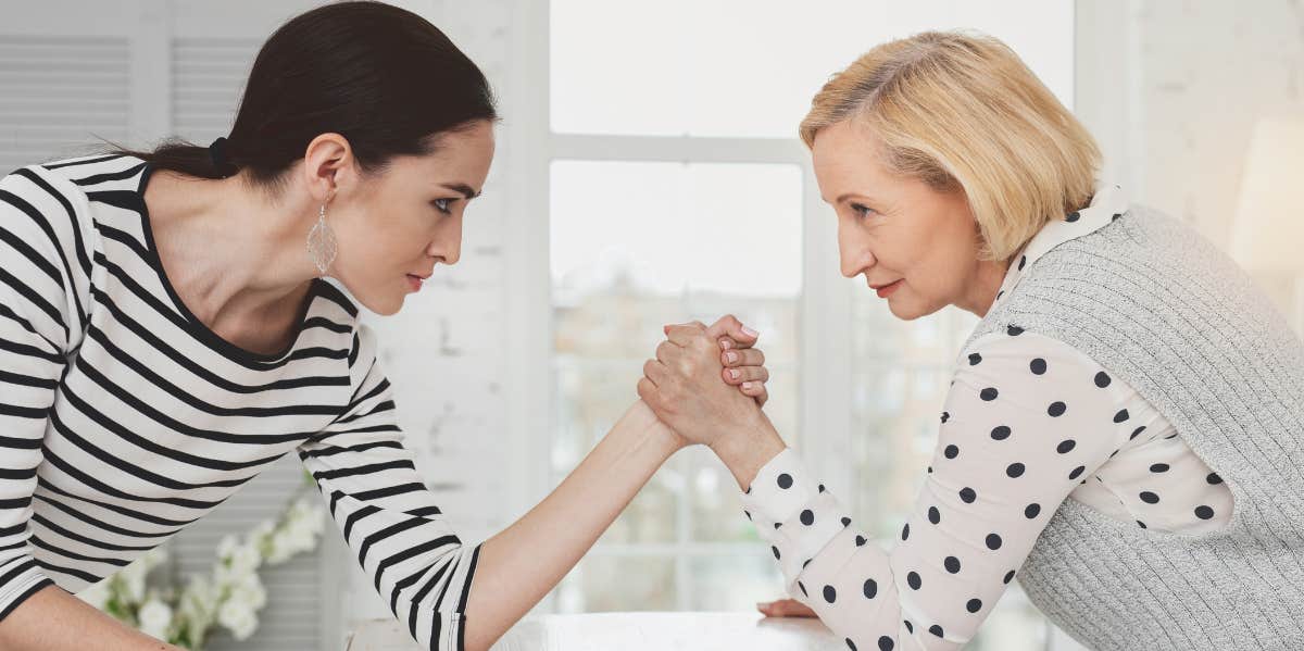 Wife and mother-in-law having an arm-wrestling match