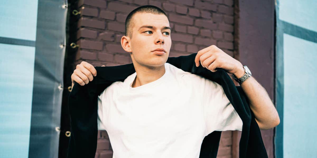 stylish man putting on jacket