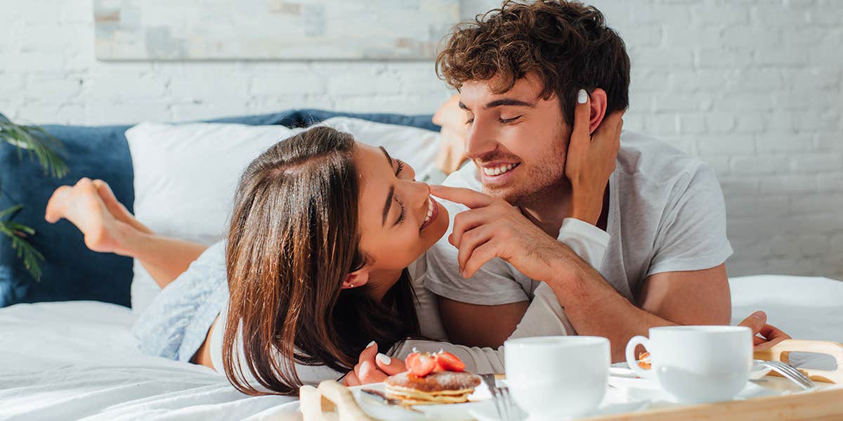 couple enjoying breakfast in bed