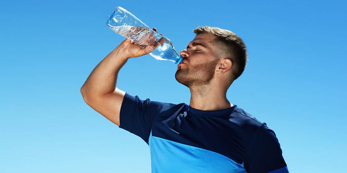 man drinking water bottle
