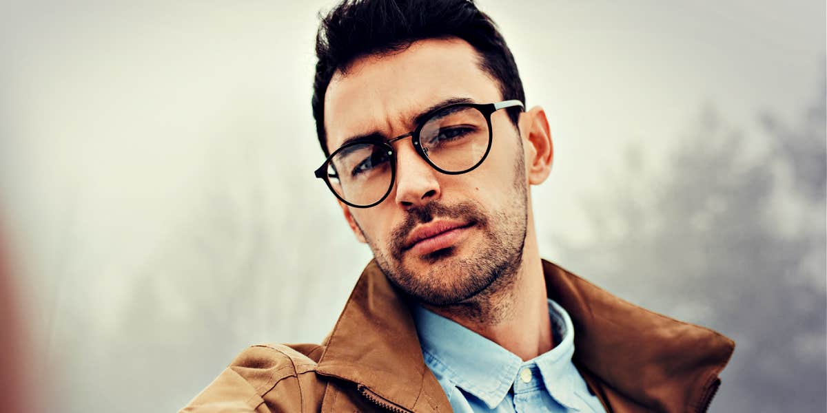 man with glasses, looking serious 